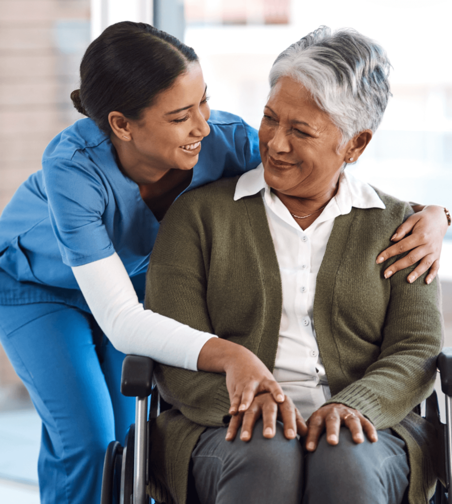 a medical worker supports a woman in a wheelchair