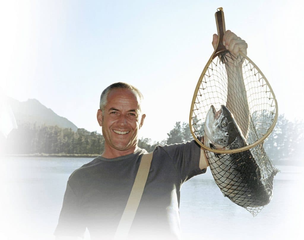 man holding fish in a net