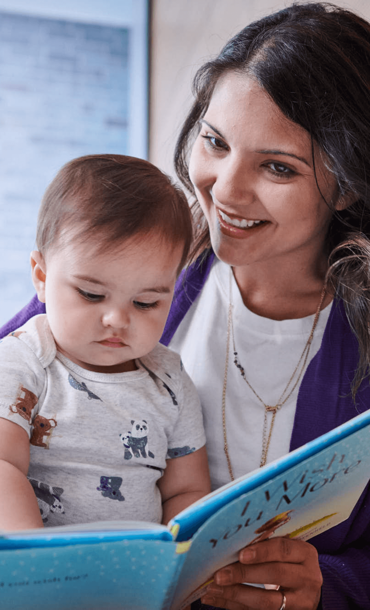 mother reads a book to the baby