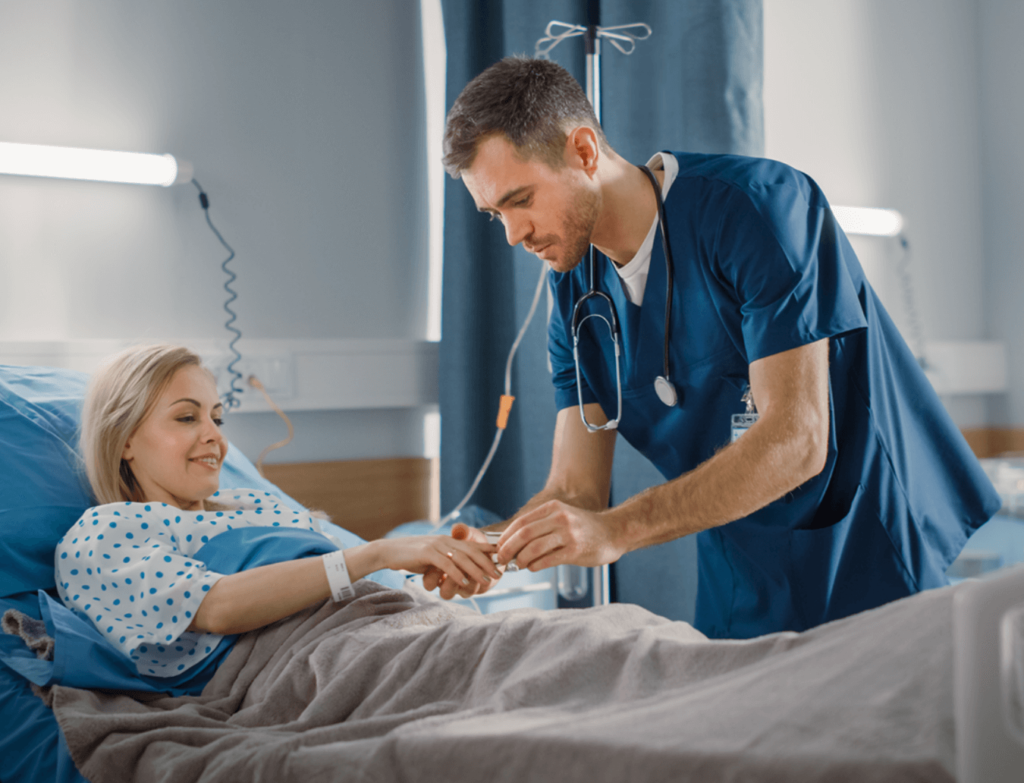 Nurse attaching monitor to patient in bed.